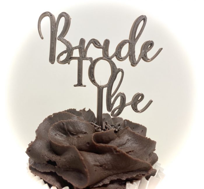 Plastic cake topper reads "Bride to Be"