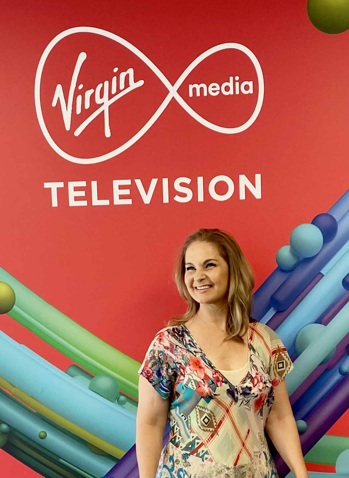 Krissy in front of Virgin Media Television logo